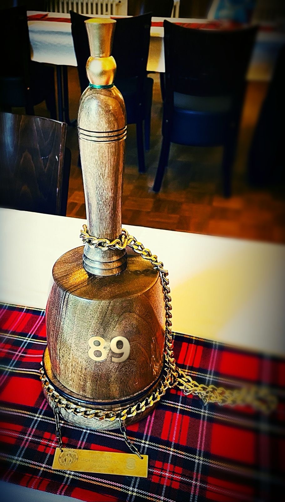 The Master's gavel bearing the number 89, resting on Scottish tartan